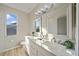 Bathroom with double vanity and marble countertop at 3405 Loggerhead Way, Wesley Chapel, FL 33544