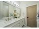 Double vanity bathroom with a large mirror and quartz countertops at 3405 Loggerhead Way, Wesley Chapel, FL 33544