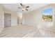 Bright bedroom with ceiling fan and wood-look flooring at 3405 Loggerhead Way, Wesley Chapel, FL 33544