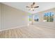 Bright bedroom with two large windows and ceiling fan at 3405 Loggerhead Way, Wesley Chapel, FL 33544