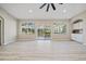 Gathering room with sliding doors to deck and light flooring at 3405 Loggerhead Way, Wesley Chapel, FL 33544