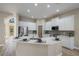 Modern kitchen with white cabinets, stainless steel appliances, and an island at 3405 Loggerhead Way, Wesley Chapel, FL 33544