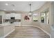 Modern kitchen featuring white cabinets and a large island at 3405 Loggerhead Way, Wesley Chapel, FL 33544