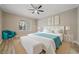 Main bedroom with king bed and teal accent chair at 3405 Loggerhead Way, Wesley Chapel, FL 33544