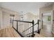 Upstairs hallway with modern light fixture and railing at 3405 Loggerhead Way, Wesley Chapel, FL 33544