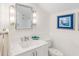 Stylish bathroom with single vanity, marble countertops, and a toilet at 4931 61St S Ave, St Petersburg, FL 33715