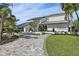 Stunning waterfront home with a metal roof, paver driveway, and lush landscaping at 4931 61St S Ave, St Petersburg, FL 33715