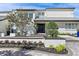 White two-story house with metal roof, landscaping, and paved driveway at 4931 61St S Ave, St Petersburg, FL 33715