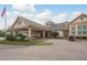 Exterior view of a clubhouse with a porte cochere and golf cart at 5935 Precious View Ct, New Port Richey, FL 34655