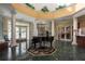 Elegant clubhouse lobby with a grand piano, marble floors, and high ceilings at 5935 Precious View Ct, New Port Richey, FL 34655