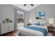 Cozy bedroom with a window view, hardwood floors, and a soothing blue and white color scheme at 12432 Country White Cir, Tampa, FL 33635