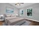 Comfortable bedroom with ample natural light, hardwood floors, and a neutral color palette at 12432 Country White Cir, Tampa, FL 33635