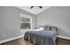 Simple bedroom with a cozy bed, a large window, and a calming gray color scheme at 12432 Country White Cir, Tampa, FL 33635