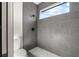 Shower with gray tile and marble hexagon floor at 1712 W Arch St, Tampa, FL 33607