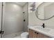 Modern bathroom with gray tile and a round mirror at 1712 W Arch St, Tampa, FL 33607