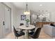 Modern dining area with round marble table and four black leather chairs at 1712 W Arch St, Tampa, FL 33607