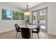 Bright dining room with round table, chairs, and French doors leading outside at 1712 W Arch St, Tampa, FL 33607