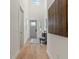 Bright entryway with hardwood floors, gray door, and modern wall art at 1712 W Arch St, Tampa, FL 33607
