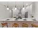 Modern kitchen island with seating, white cabinets, and quartz countertops at 1712 W Arch St, Tampa, FL 33607