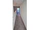 Upstairs hallway with carpet and attic access at 7002 Ripple Pond Loop, Zephyrhills, FL 33541
