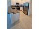 Modern kitchen with stainless steel appliances and granite countertops at 7002 Ripple Pond Loop, Zephyrhills, FL 33541