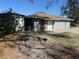 The exterior backyard showcases the home's back entrance and a unique fire pit feature at 1809 Charlow Ct, Plant City, FL 33563