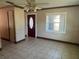 Inviting living room with a large window, neutral color palette, and a tiled floor at 1809 Charlow Ct, Plant City, FL 33563