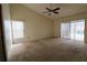 Spacious bedroom with carpet, ceiling fan, and sliding glass doors leading to a pool view at 4115 Kipling Ave, Plant City, FL 33566