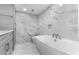 Spa-like bathroom featuring a large soaking tub and marble finishes at 1390 Gulf Blvd # 1204, Clearwater, FL 33767