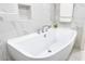 Relaxing bathroom with a soaking tub and marble tile at 1390 Gulf Blvd # 1204, Clearwater, FL 33767