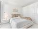 Bright bedroom with a plush bed, white built-in wardrobes and a cozy rug at 1390 Gulf Blvd # 1204, Clearwater, FL 33767