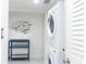 Convenient laundry room with a stackable washer and dryer at 1390 Gulf Blvd # 1204, Clearwater, FL 33767