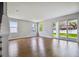 Bright living room with hardwood floors and lots of natural light from multiple windows and sliding glass door at 609 N Bradford Ave, Tampa, FL 33609