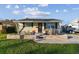 Inviting single-story home boasting a welcoming front porch and lush green lawn at 4129 36Th N Ave, St Petersburg, FL 33713