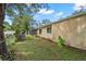 Spacious backyard with a large tree and side yard at 705 13Th Avenue Cir W, Palmetto, FL 34221