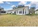Inviting backyard with enclosed patio and large, well-maintained lawn at 7231 Big Bend Dr, Spring Hill, FL 34606