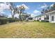 Expansive backyard featuring lush green grass and mature trees at 7231 Big Bend Dr, Spring Hill, FL 34606