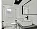 A bright bathroom features a modern vanity, white vessel sink, and black faucet at 7231 Big Bend Dr, Spring Hill, FL 34606