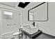 Bathroom with a modern vanity, white vessel sink, and black faucet beneath a rectangle mirror at 7231 Big Bend Dr, Spring Hill, FL 34606