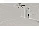 Bedroom featuring neutral carpet, a modern ceiling fan, with ensuite access to bathroom and closet at 7231 Big Bend Dr, Spring Hill, FL 34606