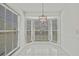 Bright dining room features white tile floors, natural light, and modern lighting at 7231 Big Bend Dr, Spring Hill, FL 34606