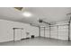 Garage with a painted floor, white walls, and cabinets for storing tools and other items at 7231 Big Bend Dr, Spring Hill, FL 34606