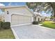 Attached two-car garage with spacious driveway and manicured landscaping at 7231 Big Bend Dr, Spring Hill, FL 34606