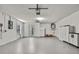 Garage with a painted floor, white walls, and cabinets for storing tools and other items at 7231 Big Bend Dr, Spring Hill, FL 34606