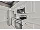 Modern kitchen features stainless steel appliances, and white cabinets at 7231 Big Bend Dr, Spring Hill, FL 34606