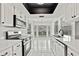 Beautiful kitchen with bright white cabinets and stainless steel appliances at 7231 Big Bend Dr, Spring Hill, FL 34606