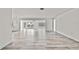 Open-concept living room with modern flooring, neutral walls, and bright windows offering ample natural light at 7231 Big Bend Dr, Spring Hill, FL 34606