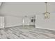 Bright living room with modern flooring and fresh white walls, featuring a stylish pendant light at 7231 Big Bend Dr, Spring Hill, FL 34606