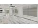 Bright living room features hardwood floors, ceiling fan, and natural light at 7231 Big Bend Dr, Spring Hill, FL 34606