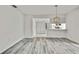 Inviting living area with modern flooring and white walls, offering seamless access to adjacent spaces at 7231 Big Bend Dr, Spring Hill, FL 34606